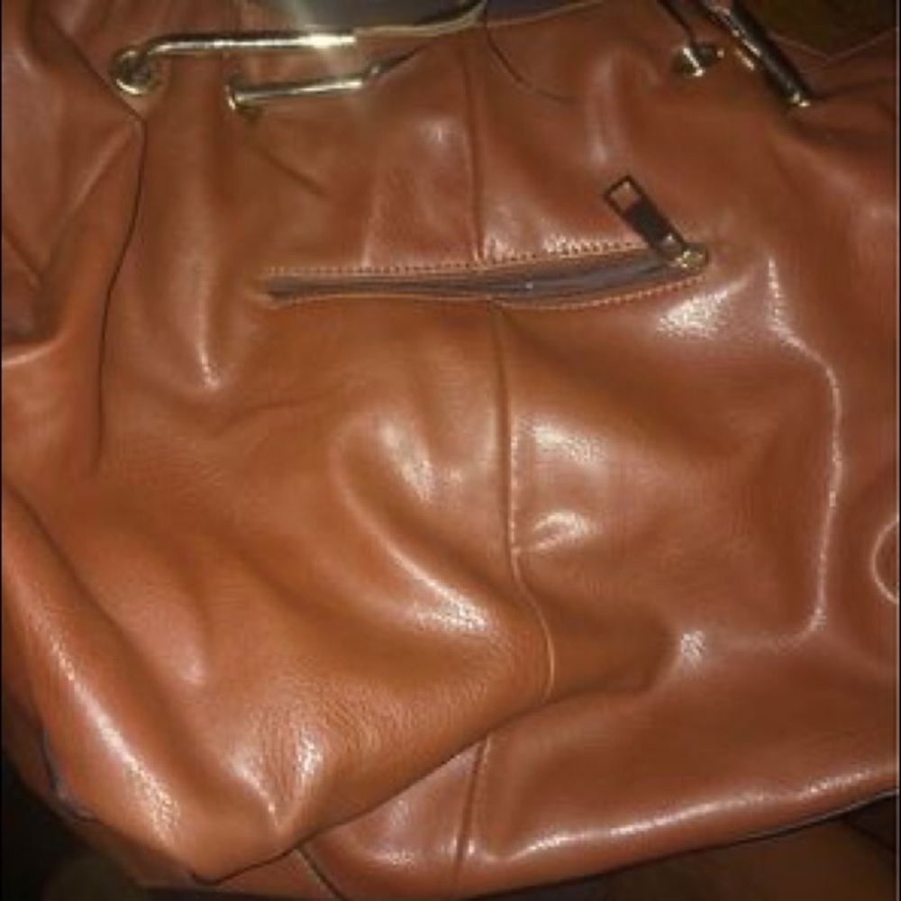 A Michael Kors Woman’s purse with matching men’s Michael Kors jacket.